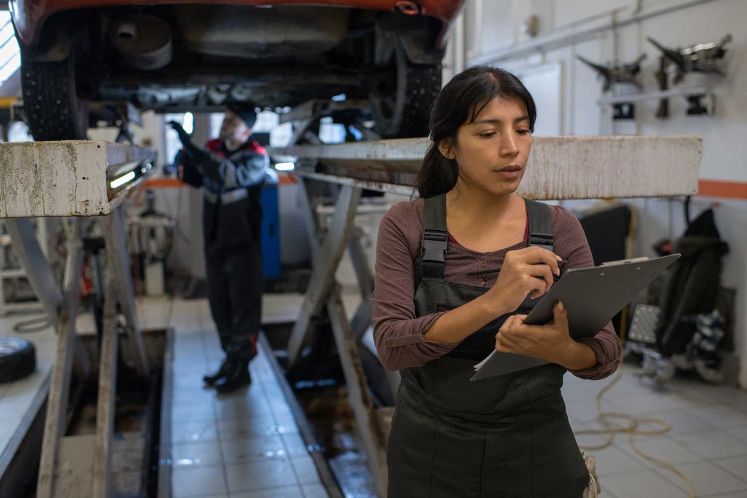 Female_Mechanic_Of_Car_Service_Making_Notes_original_3227596